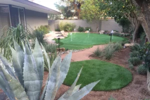 landscaped backyard with putt putt installation