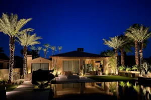 beautiful backyard is lit up with outdoor lighting